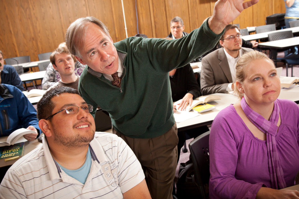 instructor guides students in activity in Oklahoma Seminary class