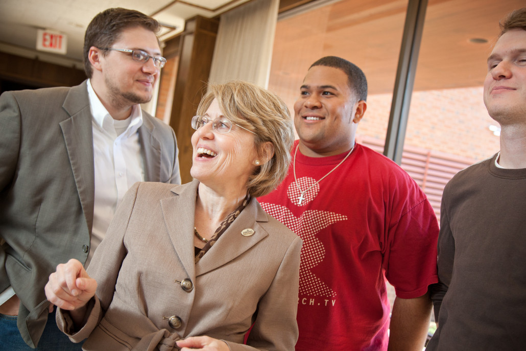 instructor laughs with Oklahoma seminary students in hallway