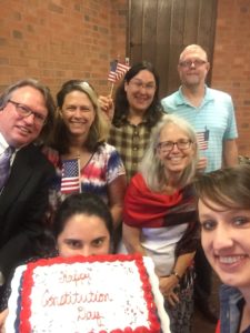 OCU staff and students celebrate Constitution Day with a cake.