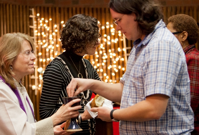 eucharistic ministers distribute bread and wine to parishioners