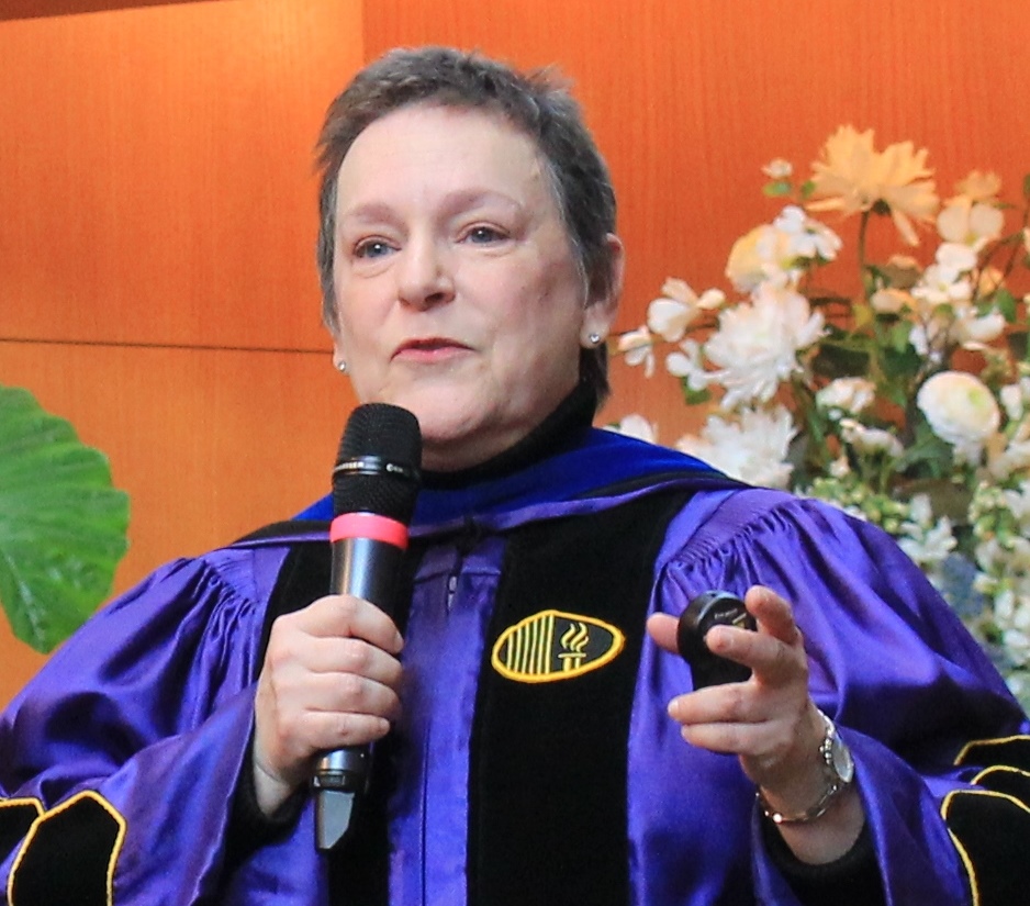 Dr. Nancy Howell speaks in her religious garb in front of her congregation