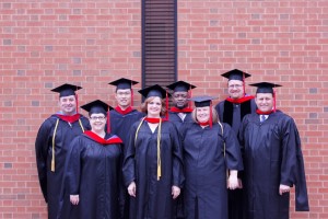 Saint Paul School of Theology Oklahoma Campus graduates throwing caps at commencement.