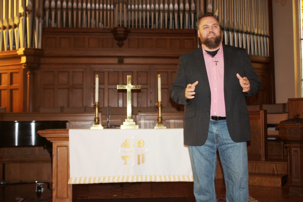 Photo of Iowa Student Fredrick Killian preaching as part of his divinity degree.