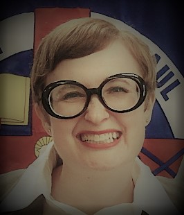 Casey Sigmon smiles widely in front of the Saint Paul School of Theology insignia.