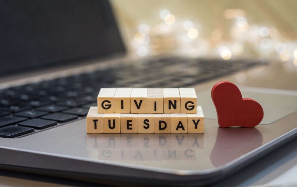 Giving tuesday letter blocks with laptop and heart
