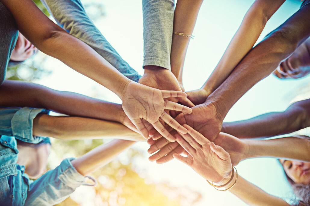 Close up of people holding hands in a circile