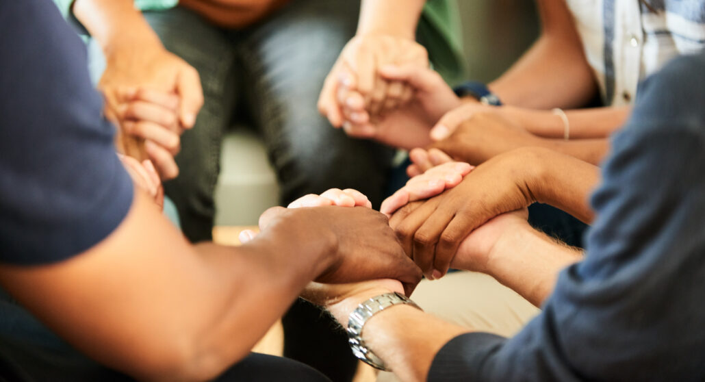 Participants holding hands during a spiritual formation retreat