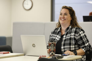 Female seminary student works on laptop while participating in Women Society and Church Studies concentration at Saint Paul